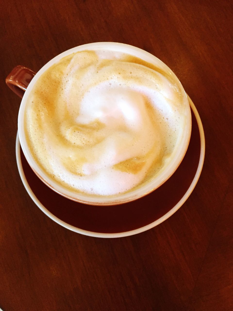 frothy drink, drink, coffee cup, food and drink, coffee - drink, refreshment, table, cappuccino, froth art, froth, saucer, latte, high angle view, no people, still life, indoors, freshness, close-up, directly above, serving size, day