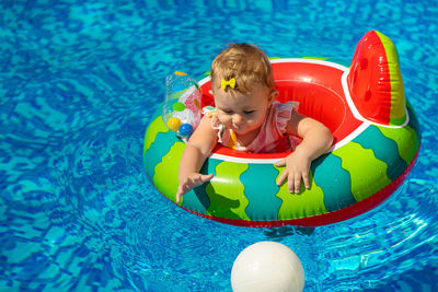 High angle view of boy swimming in pool