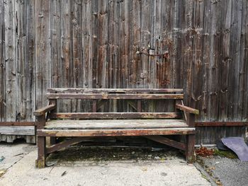 Empty bench against wall