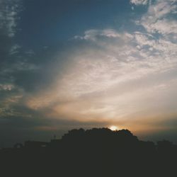Silhouette of trees against sky at sunset