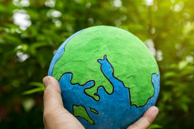 Close-up of human hand holding leaf