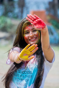 Portrait of smiling young woman standing outdoors