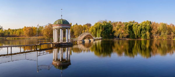 Gazebo in the middle of the lake on a sunny autumn evening in the village of ivanki,  ukraine