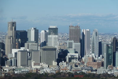 Modern buildings in city against sky in tokyo