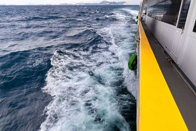 High angle view of yellow sailing ship in sea