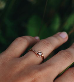 Close-up of woman hand wearing engagement ring 