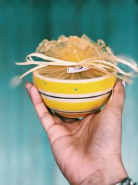 Close-up of person holding decorated bowl