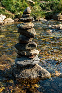 Balanced zen rock stacked stones artwork in flowing mountain stream