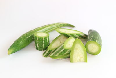 Close-up of green chili pepper against white background