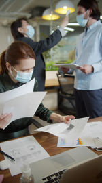 Business persons wearing mask working at office