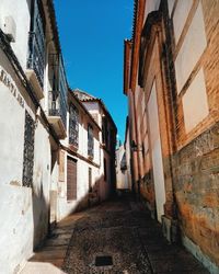 Narrow alley amidst buildings against sky