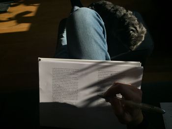 Midsection of man reading book