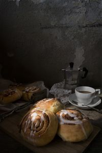 Close-up of cinnamon buns and coffee cup on table