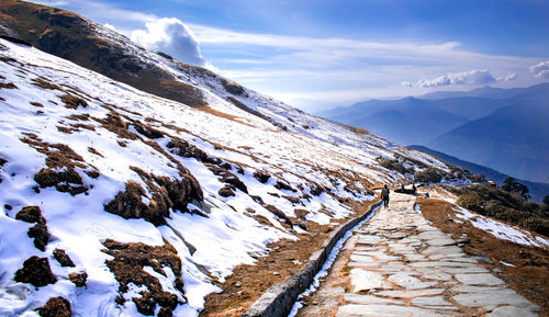 Scenic view of snow covered mountains against sky