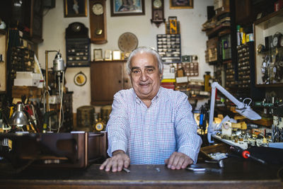 Watchmaker in his old horological smiling