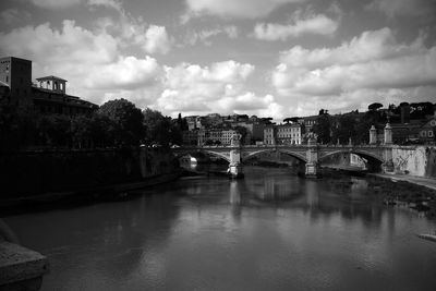 Bridge over river with buildings in background