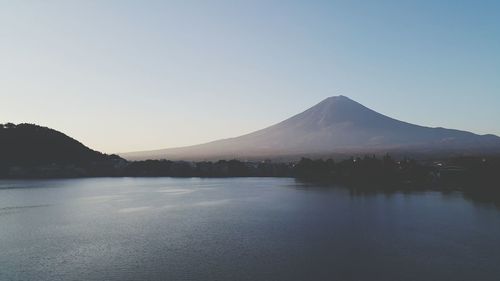 Scenic view of lake and mountains against clear sky