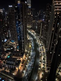 High angle view of illuminated buildings in city at night