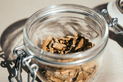 Close-up of iboga roots in jar on table