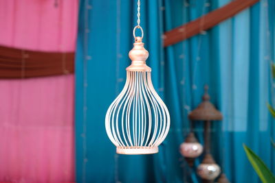 Close-up of light bulb hanging against wall