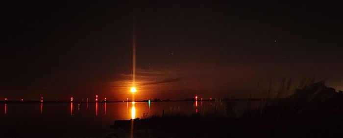 Scenic view of sea against sky at night