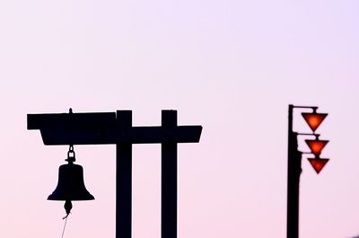 Close-up of hanging bell against clear sky