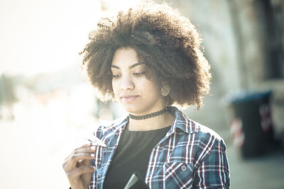 Portrait of young woman looking at camera