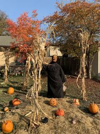 Full length of ghoul - with hay and pumpkins   during october fright festfor halloween