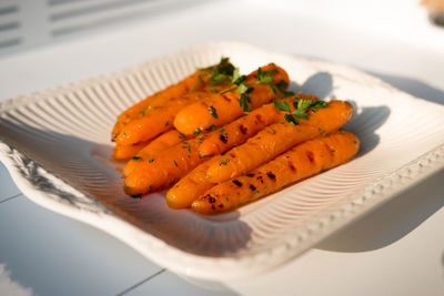 Carrots in plate on table