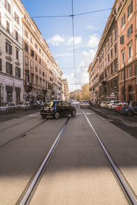 City street by buildings against sky