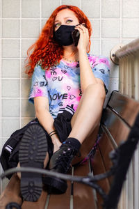 Portrait of a young woman sitting outdoors