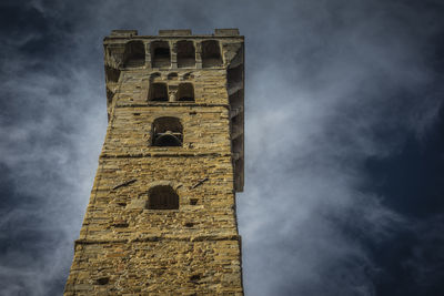 Low angle view of old building against cloudy sky