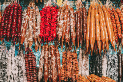 Various fruits hanging for sale at market stall