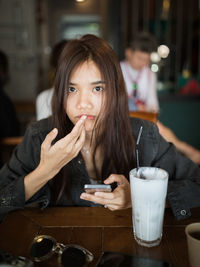Portrait of a woman drinking coffee in restaurant