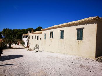 Houses against clear blue sky