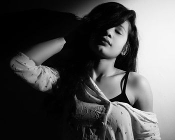 Young woman looking away against white background