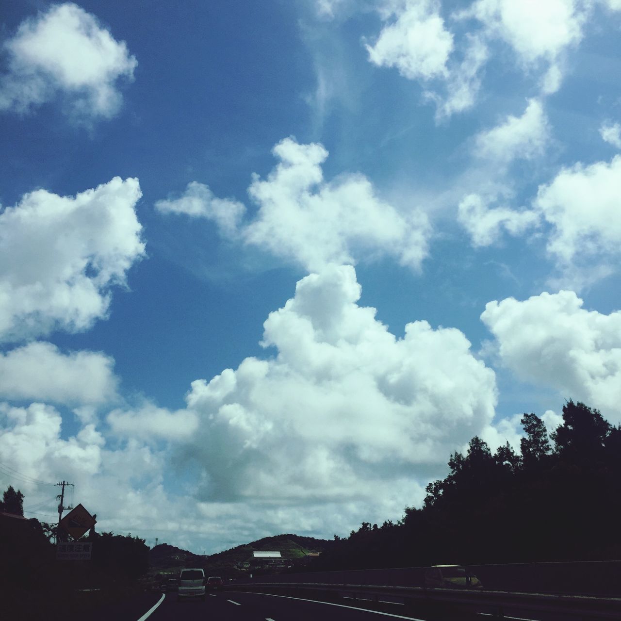 tree, sky, cloud - sky, transportation, land vehicle, travel destinations, cloud, tranquil scene, scenics, nature, blue, tourism, tranquility, day, cloudscape, outdoors, distant, non-urban scene, beauty in nature, majestic, atmosphere, vacations, no people, cloudy