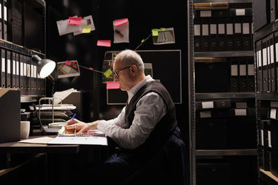 Side view of businessman working at table