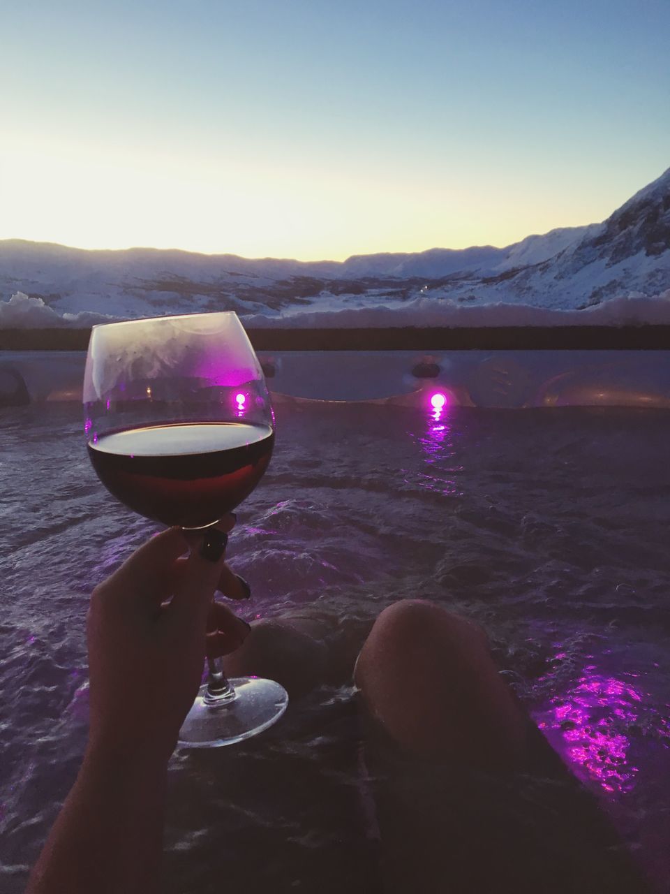 water, mountain, food and drink, person, freshness, clear sky, part of, drink, lifestyles, refreshment, holding, reflection, cropped, leisure activity, lake, beauty in nature, drinking glass
