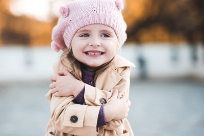 Cute girl wearing knit hat looking away