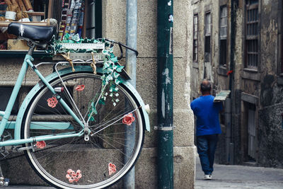 Man standing on bicycle in city