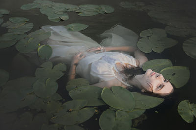 Close-up of young woman in water