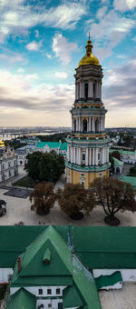 View of buildings in city against cloudy sky