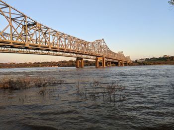 View of bridge over river against clear sky