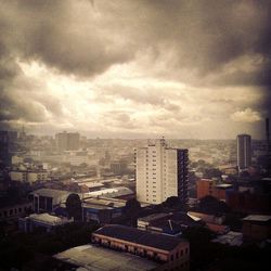 Cityscape against cloudy sky