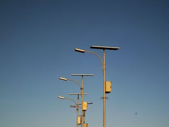 Low angle view of street light against clear blue sky