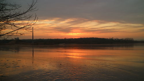 Scenic view of river against sky during sunset