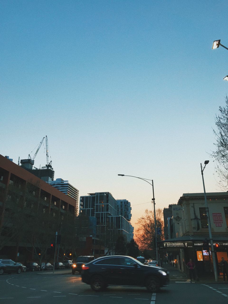 CARS ON STREET AGAINST CLEAR SKY