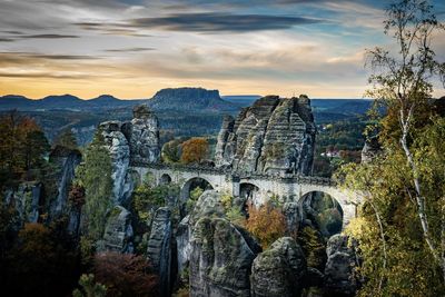 Panoramic view of rock formation against sky during sunset