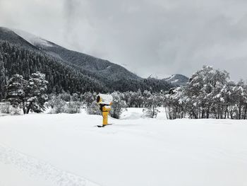 Snow covered landscape against sky